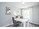 Home office featuring a white desk, comfortable chairs, shelving, and natural light at 355 Fosterton Cottage Way, Raleigh, NC 27603