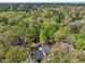Breathtaking aerial view of a home nestled in a dense forest, complete with a tranquil pond at 363 Dublin Dr, Sanford, NC 27330