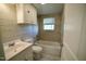 A refreshed bathroom with a bathtub, white cabinets and tile walls at 3728 Gideon Dr, Wake Forest, NC 27587