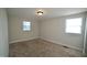 This bedroom has neutral walls, carpeted floors, and two windows for natural light at 3728 Gideon Dr, Wake Forest, NC 27587
