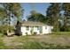View of a home with a wooden deck, set on a large lot with mature trees at 3728 Gideon Dr, Wake Forest, NC 27587