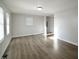 Bright living room featuring modern flooring, light walls, and natural light from the windows at 3728 Gideon Dr, Wake Forest, NC 27587