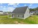 Spacious backyard with lush green grass and a covered patio, creating a private and serene outdoor space at 396 Martins Mill Ct, Wendell, NC 27591