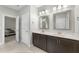 Bright bathroom with double sink vanity, tile flooring, and linen closet leads to the bedroom at 396 Martins Mill Ct, Wendell, NC 27591
