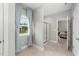 Bathroom featuring tile flooring, window with curtains, shower, and doorway to bedroom at 396 Martins Mill Ct, Wendell, NC 27591