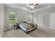 Spacious bedroom with tray ceiling, ceiling fan, carpeted floors, and two windows with natural light at 396 Martins Mill Ct, Wendell, NC 27591