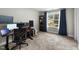This bedroom is currently used as a home office, featuring plush carpet and abundant natural light at 396 Martins Mill Ct, Wendell, NC 27591