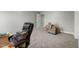 Neutral bedroom with plush carpet and chair, can easily be staged to the buyer's preference at 396 Martins Mill Ct, Wendell, NC 27591