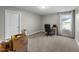 Neutral bedroom with a window with curtains, carpeted floors, and a built-in desk area by the window at 396 Martins Mill Ct, Wendell, NC 27591