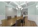 Elegant dining room featuring a coffered ceiling, modern chandelier, and stylish decor at 396 Martins Mill Ct, Wendell, NC 27591