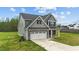 Stately two-story home with attached garage and well-maintained landscaping, blending curb appeal with functionality at 396 Martins Mill Ct, Wendell, NC 27591