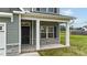 Welcoming front porch with stone accents and a classic black door, creating a warm and inviting entrance at 396 Martins Mill Ct, Wendell, NC 27591
