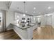 Modern kitchen with white cabinets, stainless steel appliances, stylish countertops and breakfast bar seating at 396 Martins Mill Ct, Wendell, NC 27591