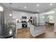 Modern kitchen with white cabinets, stainless steel appliances, a kitchen island and beautiful countertops at 396 Martins Mill Ct, Wendell, NC 27591