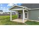 Covered patio with gray siding and a well-manicured lawn, perfect for outdoor relaxation and entertaining at 396 Martins Mill Ct, Wendell, NC 27591