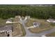 An aerial view captures multiple homes in a community, each featuring landscaped yards and serene surroundings at 40 Patricia S Vann Ct, Dunn, NC 28334
