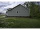 Side exterior of home with brick and vinyl siding overlooking the yard at 40 Patricia S Vann Ct, Dunn, NC 28334