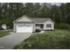 Charming home featuring a two-car garage, inviting front porch, and freshly landscaped front yard at 40 Patricia S Vann Ct, Dunn, NC 28334
