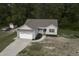 Aerial front exterior displays a house with an attached two-car garage, and well-kept yard with landscaping at 40 Patricia S Vann Ct, Dunn, NC 28334