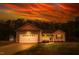 Charming single-story home with an attached garage and manicured lawn under a dramatic sunset sky at 40 Patricia S Vann Ct, Dunn, NC 28334