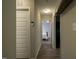 Hallway with coat rack leading to bedroom showcasing hardwood style flooring at 40 Patricia S Vann Ct, Dunn, NC 28334