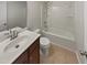 Bathroom featuring a single sink vanity, neutral walls, tile floors, and a shower-tub combo at 400 Collington Dr, Mebane, NC 27302