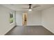 Light filled bedroom featuring a ceiling fan, neutral walls, carpet floors, and an adjacent walk-in closet at 400 Collington Dr, Mebane, NC 27302