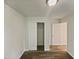 Bedroom showcasing sliding closet doors, wood-look floors, white walls and trim, and modern light fixture at 400 Collington Dr, Mebane, NC 27302