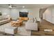 Comfortable living room featuring a ceiling fan, plush seating, a modern TV setup, and warm, inviting lighting at 400 Collington Dr, Mebane, NC 27302