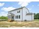 Rear view of white two-story home, highlighting a screened porch and exterior features with blue sky at 420 Shelby Meadow Ln, Angier, NC 27501