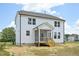 A spacious backyard features a two-story home with a screened porch and white vinyl siding at 420 Shelby Meadow Ln, Angier, NC 27501