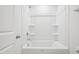 Bright white tub/shower combo with neutral finishes in a clean bathroom at 420 Shelby Meadow Ln, Angier, NC 27501