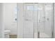 Modern shower featuring glass doors, elegant tilework, and rainfall showerhead at 420 Shelby Meadow Ln, Angier, NC 27501