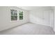 Comfortable bedroom with carpeting, a double closet and a view of greenery through the windows at 420 Shelby Meadow Ln, Angier, NC 27501