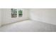 Well-lit bedroom featuring large windows and neutral carpeting, creating a serene atmosphere at 420 Shelby Meadow Ln, Angier, NC 27501