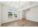 Dining room with coffered ceilings, wood floors, a modern chandelier, and large windows for ample natural light at 420 Shelby Meadow Ln, Angier, NC 27501