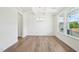 Elegant dining room with coffered ceilings, modern chandelier, wood flooring, and large window for natural light at 420 Shelby Meadow Ln, Angier, NC 27501