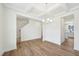 Open dining room space with coffered ceilings, modern chandelier, and wood floors, providing an elegant setting at 420 Shelby Meadow Ln, Angier, NC 27501