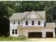 New construction home featuring a two-car garage and classic architectural details. Ready for final finishing at 420 Shelby Meadow Ln, Angier, NC 27501