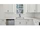 Modern kitchen sink with quartz countertops, tiled backsplash, stainless steel appliances, and black hardware at 420 Shelby Meadow Ln, Angier, NC 27501