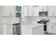 Bright kitchen with white cabinets, quartz countertops, stainless steel appliances, and a stylish island at 420 Shelby Meadow Ln, Angier, NC 27501