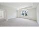 Spacious main bedroom with tray ceiling, large windows, and soft carpeting, creating a tranquil retreat at 420 Shelby Meadow Ln, Angier, NC 27501