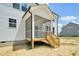 New construction shows a charming screened porch, with wooden stairs and white railing at 420 Shelby Meadow Ln, Angier, NC 27501
