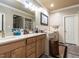 Bright bathroom with double sinks, wood cabinets, a large mirror, and ample counter space at 4203 Norman Ridge Ln, Raleigh, NC 27613