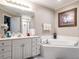 Bright bathroom featuring a soaking tub, double vanity, and ample counter space at 4203 Norman Ridge Ln, Raleigh, NC 27613