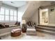 A quaint bonus room with built in seating area, a chair, and a small set of steps at 4203 Norman Ridge Ln, Raleigh, NC 27613