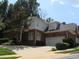 Charming two-story brick home with well-manicured landscaping and a spacious driveway, under a clear blue sky at 4203 Norman Ridge Ln, Raleigh, NC 27613