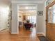 Inviting foyer showcasing a dining room with hardwood floors, shutters, and a chandelier, viewed from the front entrance at 4203 Norman Ridge Ln, Raleigh, NC 27613