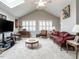 Bright living room under skylight featuring neutral color scheme and vaulted ceilings at 4203 Norman Ridge Ln, Raleigh, NC 27613