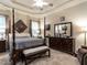 Spacious main bedroom featuring neutral tones, a tray ceiling, and elegant dark wood furniture at 4203 Norman Ridge Ln, Raleigh, NC 27613